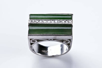 A jade and diamond ring, the two bar set oblong jade stones separated by a single row of bead set diamonds in a pierced setting. White gold. Weight 13.37grams. Size M.