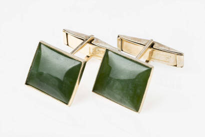 A pair of nephrite cufflinks, the rectangular cabochon nephrite stones measuring 14 x 11mm set in a rubover mount. 9ct yellow gold. Weight 7.20 grams.