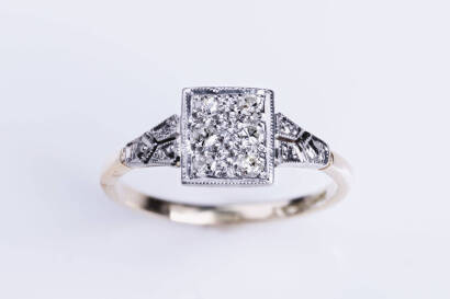 A diamond ring with six old cut diamonds bead set in a plaque mount. 18ct yellow gold and platinum. Weight 2.95 grams. Size M. Circa 1920's.
