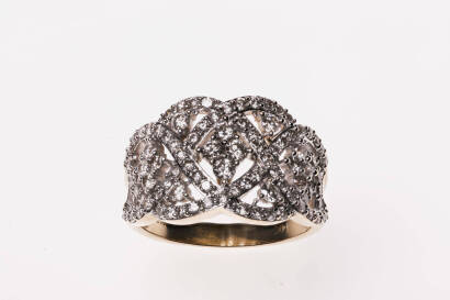 A diamond dress ring with round brilliant diamonds set into an open-work trellis design mount. 14ct white and yellow gold. Weight 6.67 grams. Size O.