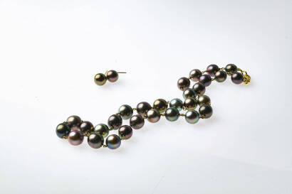 A cultured pearl necklace and earrings the 29 x 9.5mm-11.2mm graduated peacock coloured pearls linked by twisted jump rings, and hung with 18ct yellow gold parrot clasp. Length 46cm. To be sold with a pair of matching pearl drop earrings.18ct yellow gold.