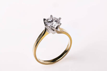 A solitaire diamond ring, of estimated weight 1.10 carats set in a six spiral clawed mount. 18ct yellow and white gold. Weight 3.0 grams. Ring size L.&nbsp;