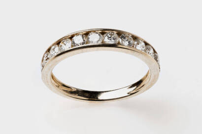 A diamond band ring, the front section channel set with 12 round brilliant diamonds of estimated weight 0.80 carat. 9ct yellow gold. Weight 2.41 grams. Size P.&nbsp;