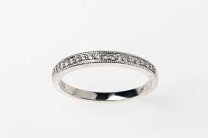 A diamond ring, 19 round brilliant cut diamonds are bead set with milled edging across top of band. 9ct white gold. Weight 2.03 grams. Size O.