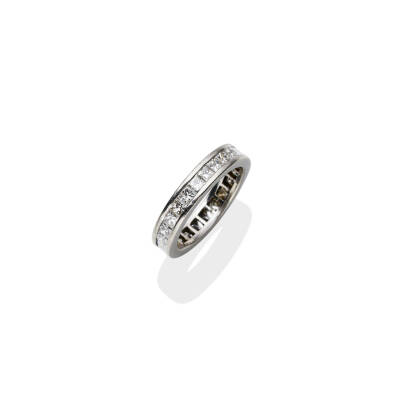 A diamond eternity ring, channel set all around with twenty-three princess cut diamonds of estimated total weight 1.80 carats. Platinum. Weight 4.74 grams. Size J &frac12;.