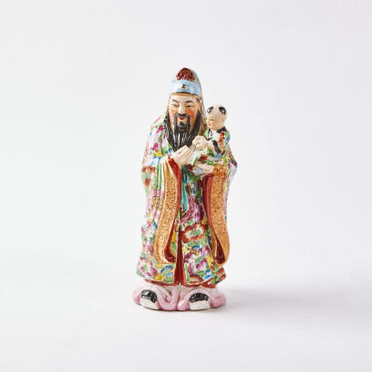 A Chinese Immortal And Child Ceramic Figurine