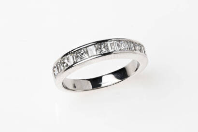 A diamond band ring with seven princess cut and six baguette diamonds of estimated weight 0.50 carat, channel set alternating across top of band. 18ct white gold. Weight 3.8 grams. Size J.