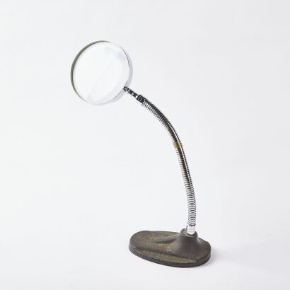 An Articulating Magnifying Glass With Cast Iron Base