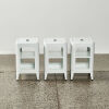 A Trio Of White Metal Storage Stools