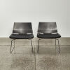 A Pair Of Black Modernist Chairs Moulded Ply With Leather Squabs