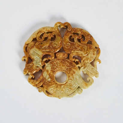 An old Chinese jade disc 'double mythical beasts' pendant