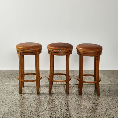 A Set Of Three Leather Topped Bar Stools