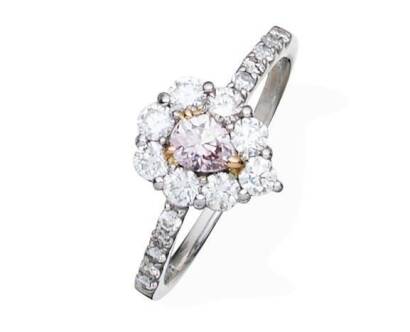 A pink and white diamond ring, the central pear-shaped pink diamond of known weight 0.236 carat, surrounded by eight round brilliant cut diamonds and diamond set shoulders, total known weight 0.61 carat. 18ct white gold and platinum. Weight 3.47 grams. Si