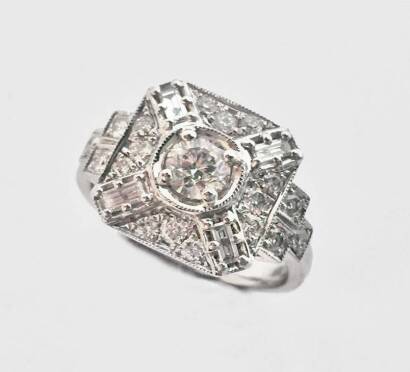 A diamond ring, the square plaque ring set with brilliant and baguette diamonds. Total known weight 1.0 carat.&nbsp;18ct white gold. Weight 7.4 grams. Size N.