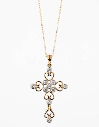 A gold and diamond cross, the filigree style cross set with ten modern round brilliant cut diamonds of known weight 0.56 carat. 9ct yellow gold. Weight 2.5 grams. Length 40mm. To be sold with a fine trace link chain. 18ct yellow gold. Weight 1.5 grams. Le