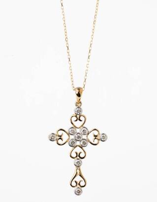 A gold and diamond cross, the filigree style cross set with ten modern round brilliant cut diamonds of known weight 0.56 carat. 9ct yellow gold. Weight 2.5 grams. Length 40mm. To be sold with a fine trace link chain. 18ct yellow gold. Weight 1.5 grams. Le