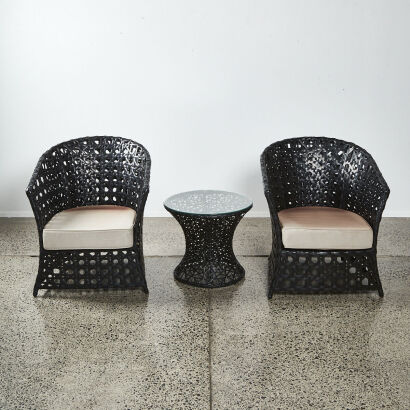 An Outdoor Furniture Set Of Two Black Woven Arm Chairs And Circular Table