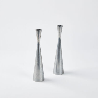 A Pair Of Cast Aluminium Candle Holders