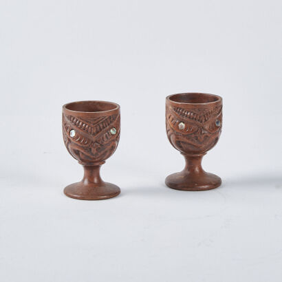 Pair Of Carved Egg Cups With Paua Inserts