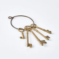 A Collection Of Five Large Brass Keys On A Ring