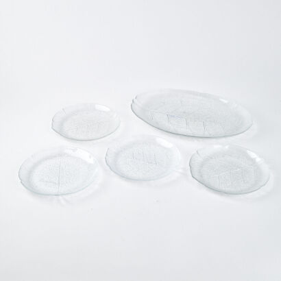 A Set Of Four Glass Leaf Plates