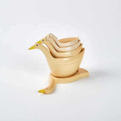 A Collection Of Four Retro Goose Measuring Cups With Base