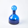 A Vintage Blue Glass Bottle With Large Stopper