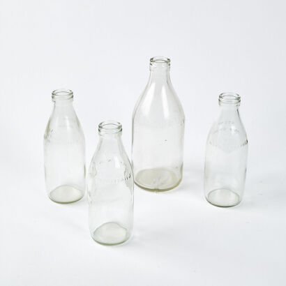 A Collection Of Four Vintage Glass Milk Bottles