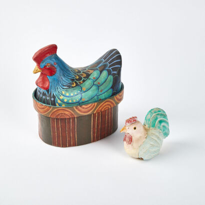 A Small Wooden Chicken and Paper Mache Chiken in a Basket