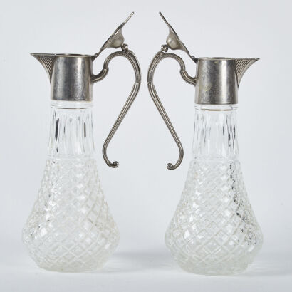 A Pair Of Cut Glass Pitchers With Silver Plated Handle And Spout