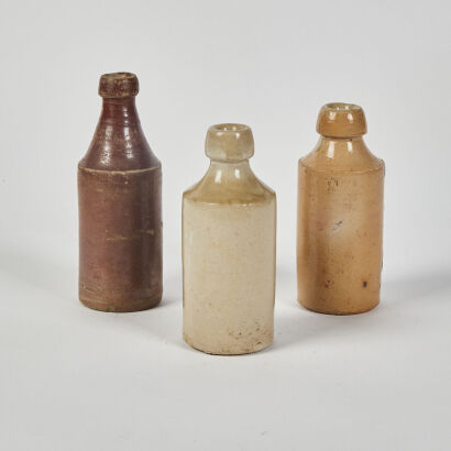 A Trio Of Antique Stoneware Bottles