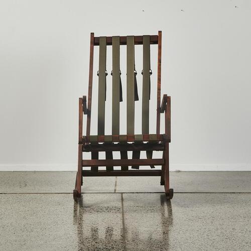 A Rocking Chair With Webbing Seating