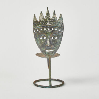 A Rustic Metal Theatre Mask Candle Holder