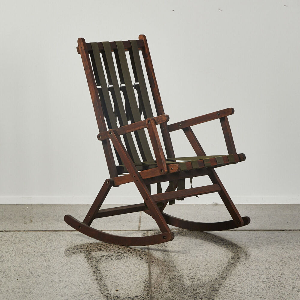 A Rocking Chair With Webbing Seating