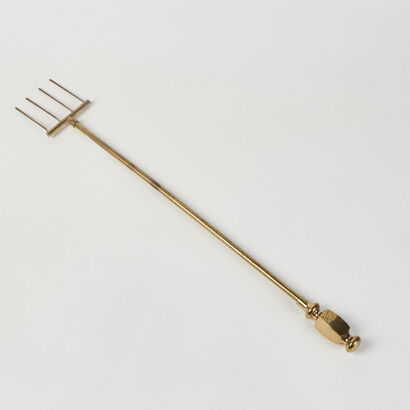 A Long Brass Four Pronged Fork