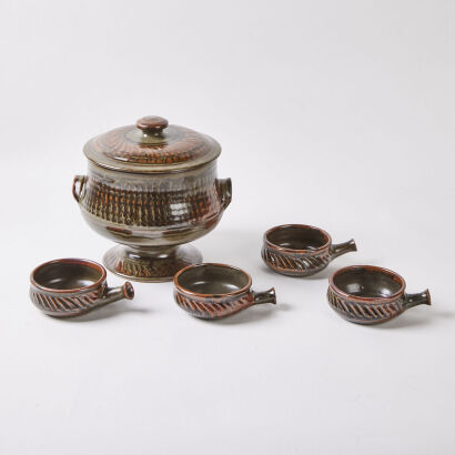 An Ovenware Dish on a Stand with Four Bowls