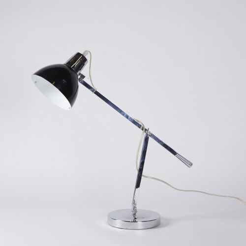 An Articulated Chrome And Black Desk Lamp