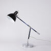 An Articulated Chrome And Black Desk Lamp