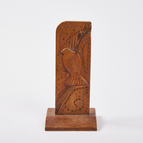 A Wood Carved Sculpture Depicting a Kererū