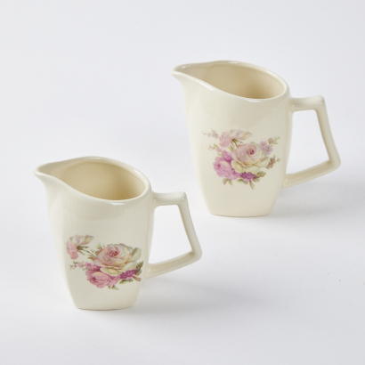 A Pair Of Titan Floral Table Jugs