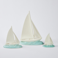 A Set Of Three Poole Pottery Racing Yachts Designed By John Adams And Modelled By Harry Brown