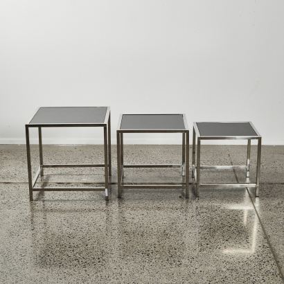 A Set of Three Glass and Chrome Nesting Tables