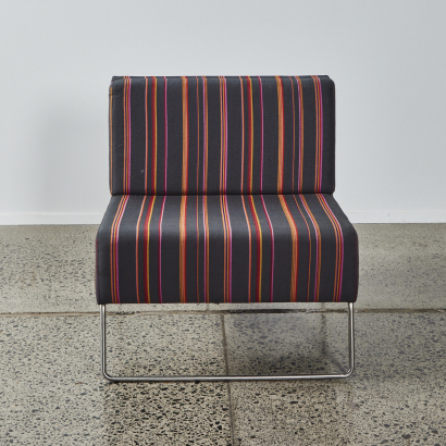 A Minimal Designer Chair With Stainless Base In Striped Fabric