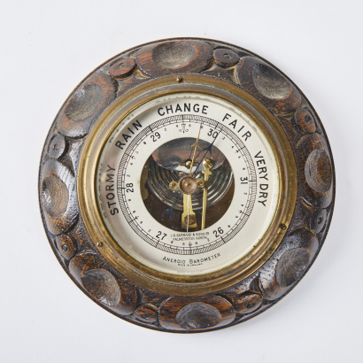 A Barometer With Carved Wood Base