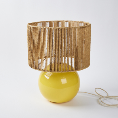 A Yellow Ceramic Gumball Lamp With String Shade