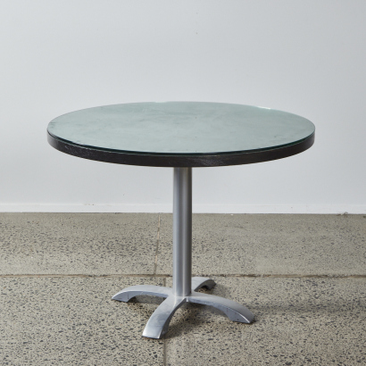 A Circular Dining Table With A Glass Overlay