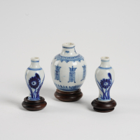 A set of three Chinese Qing dynasty blue and white small vases