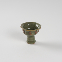 A Chinese Yuan dynasty Longquan celadon-glazed 'figural' octagonal cup