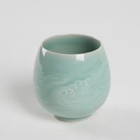 A Chinese 'Longquan' celadon-glazed engraved flower tea cup (Zhan qiaoming stamp)