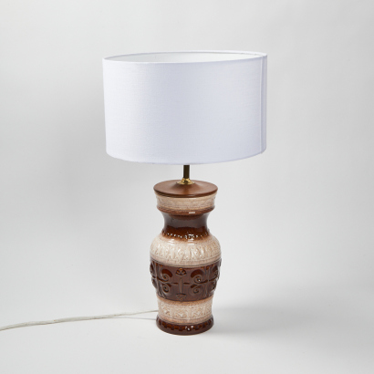 A Decorative Ceramic Lamp With Shade